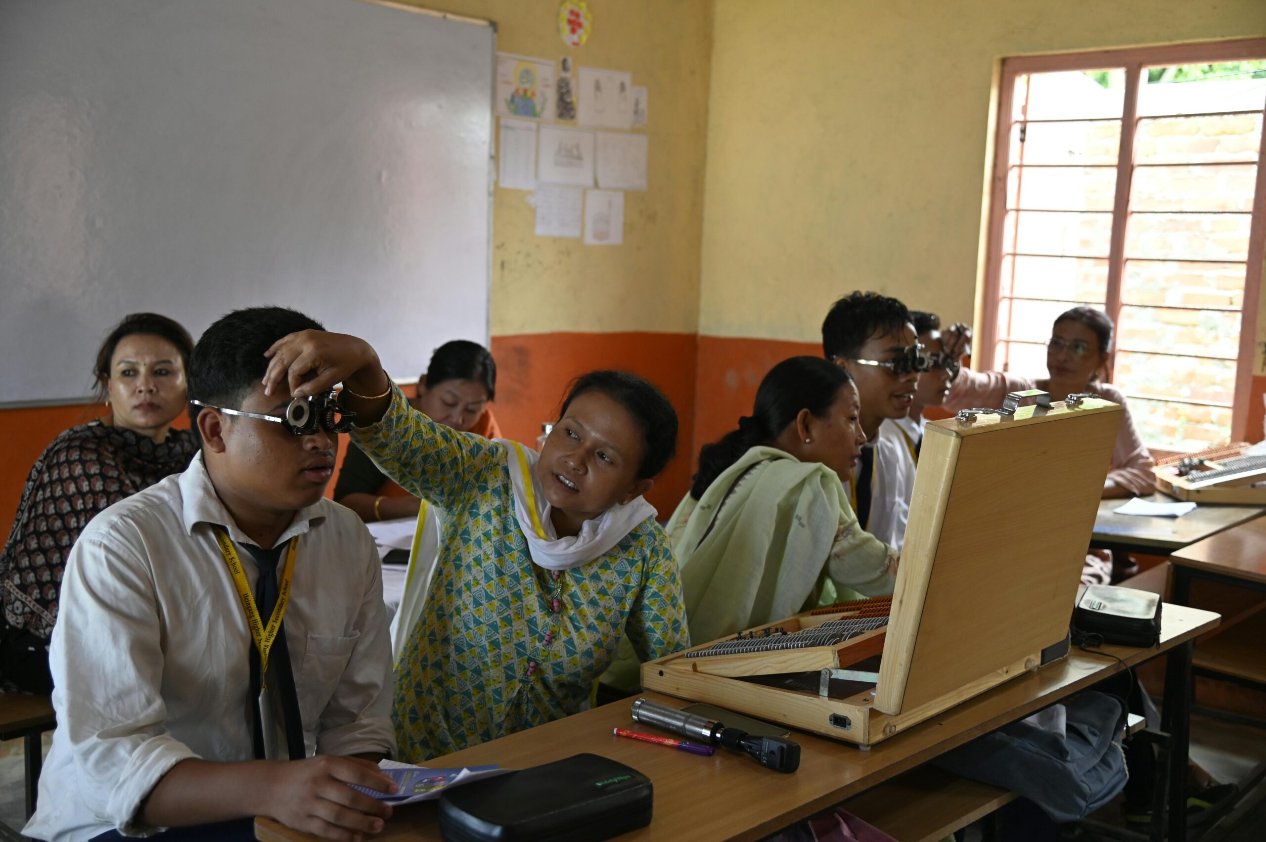 Educational vision screening session for children in an Indian classroom, promoting eye care.