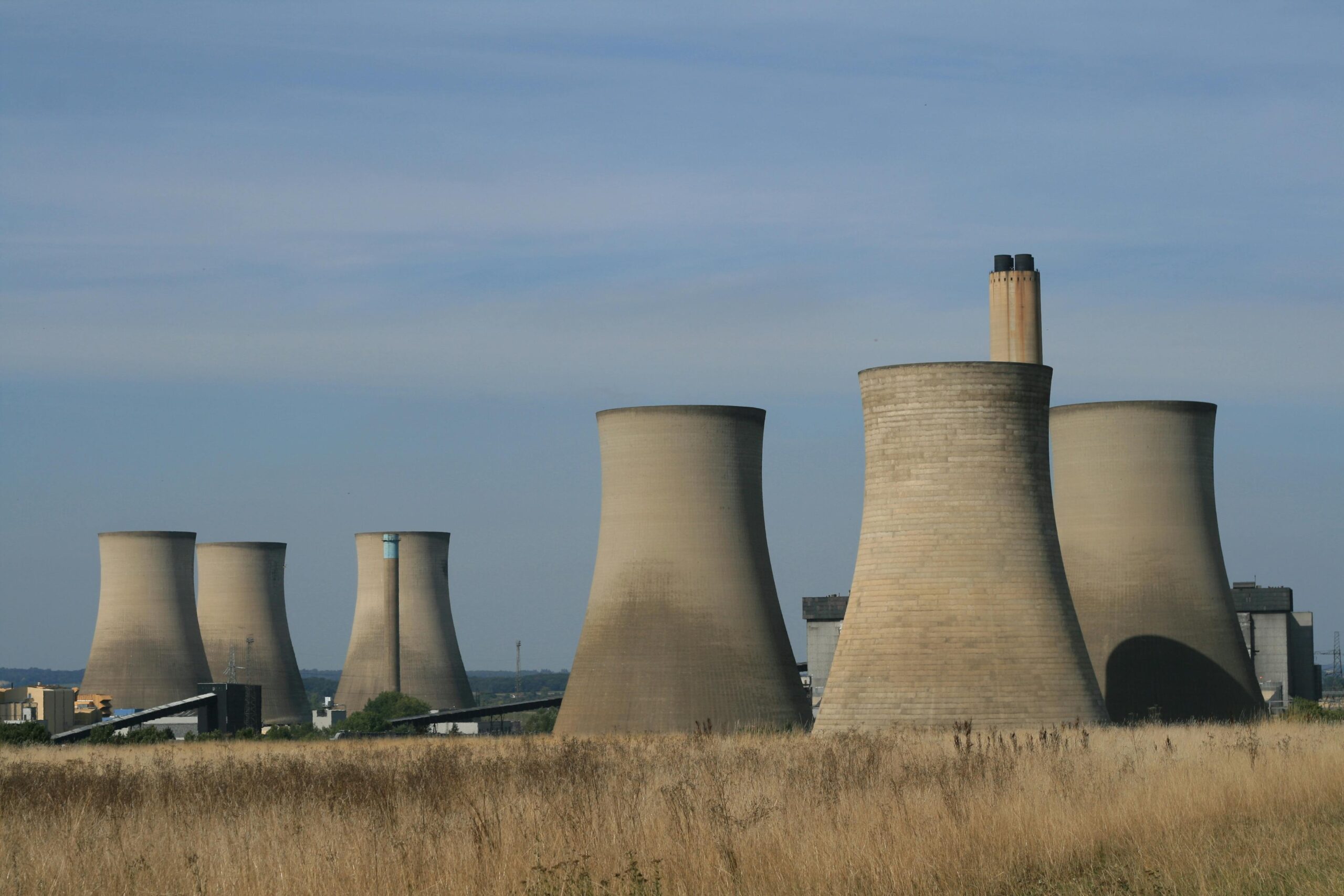 Landscape view of cooling towers at Didcot Power Station in England, showcasing industrial architecture.